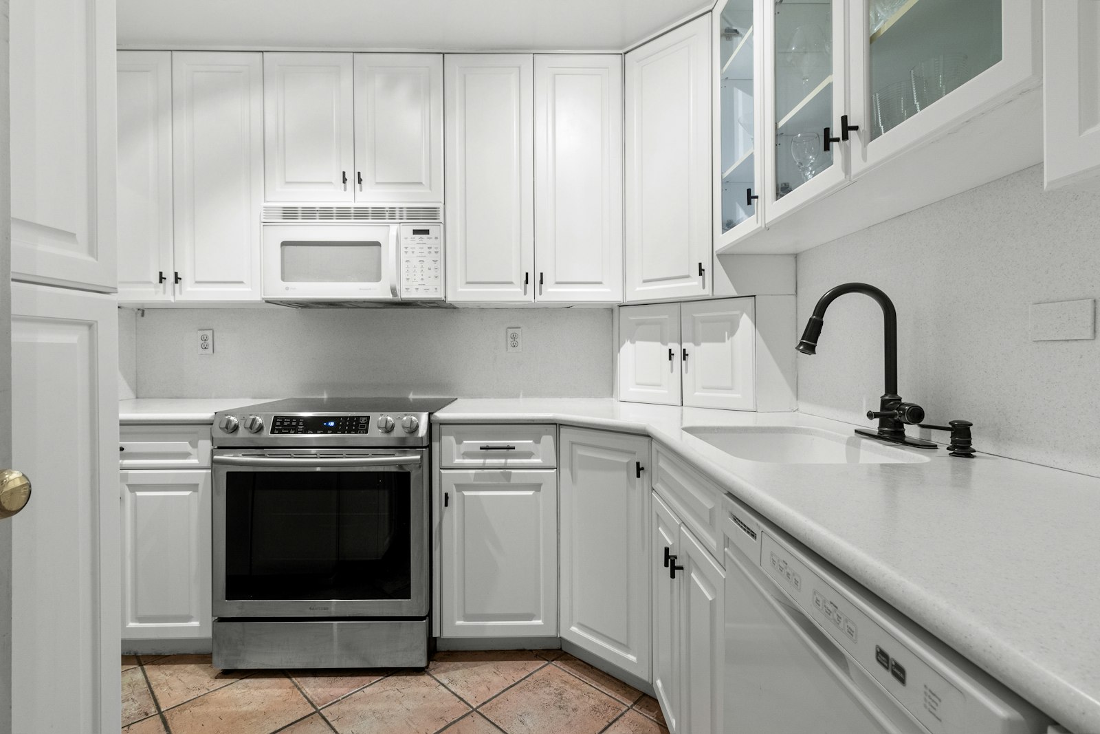 The same style of kitchen after: white painted cabinets and updated hardware