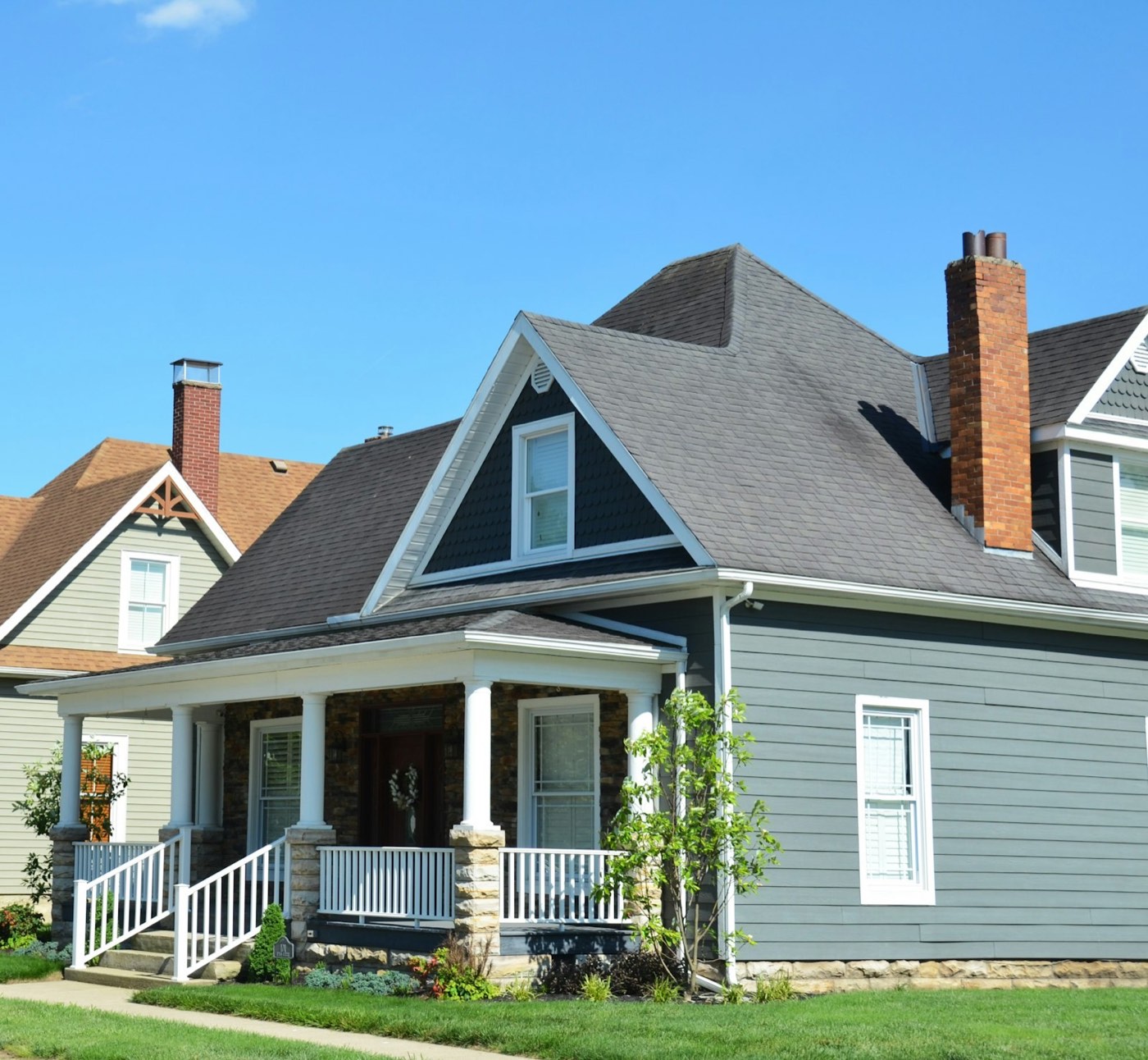 Repainted home exterior with clean gray siding and white trim